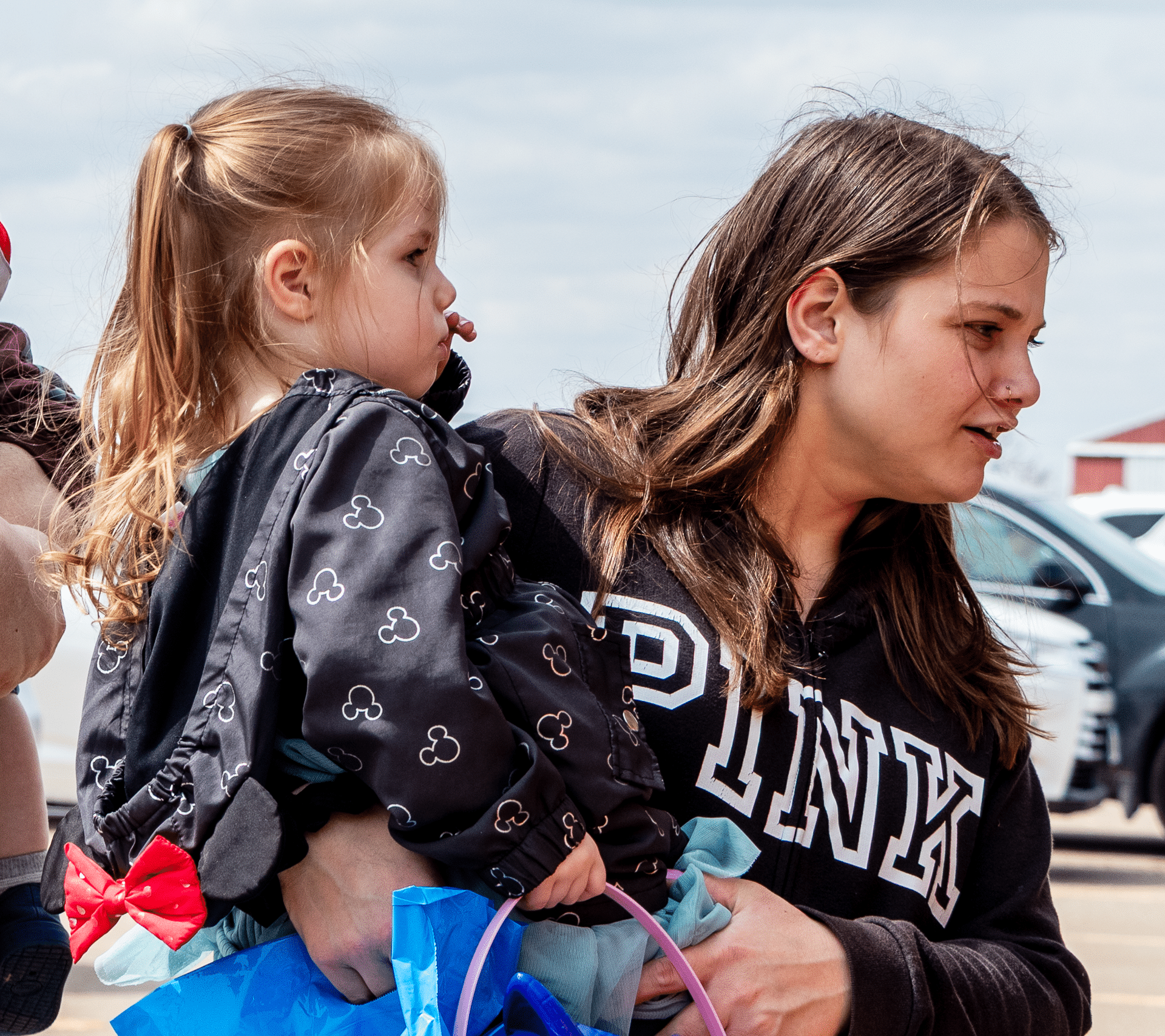 A smiling woman and young girl share a joyful moment outside—welcoming all with love, hope, and community. - Muscatine Church of Christ