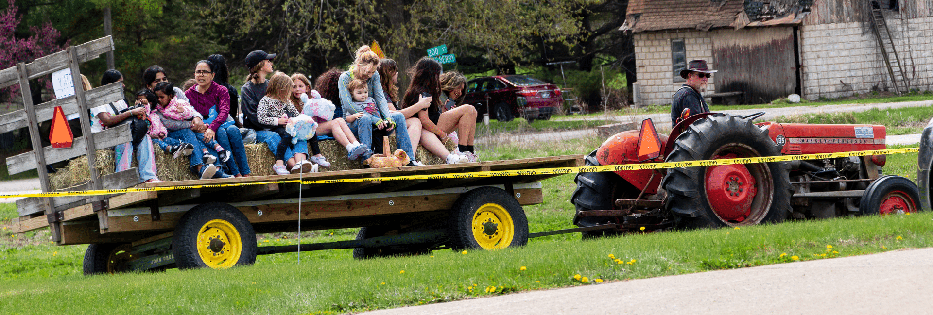 Families and friends of all ages share a joyful hayride together, warmly welcoming everyone to join the fun. - Muscatine Church of Christ