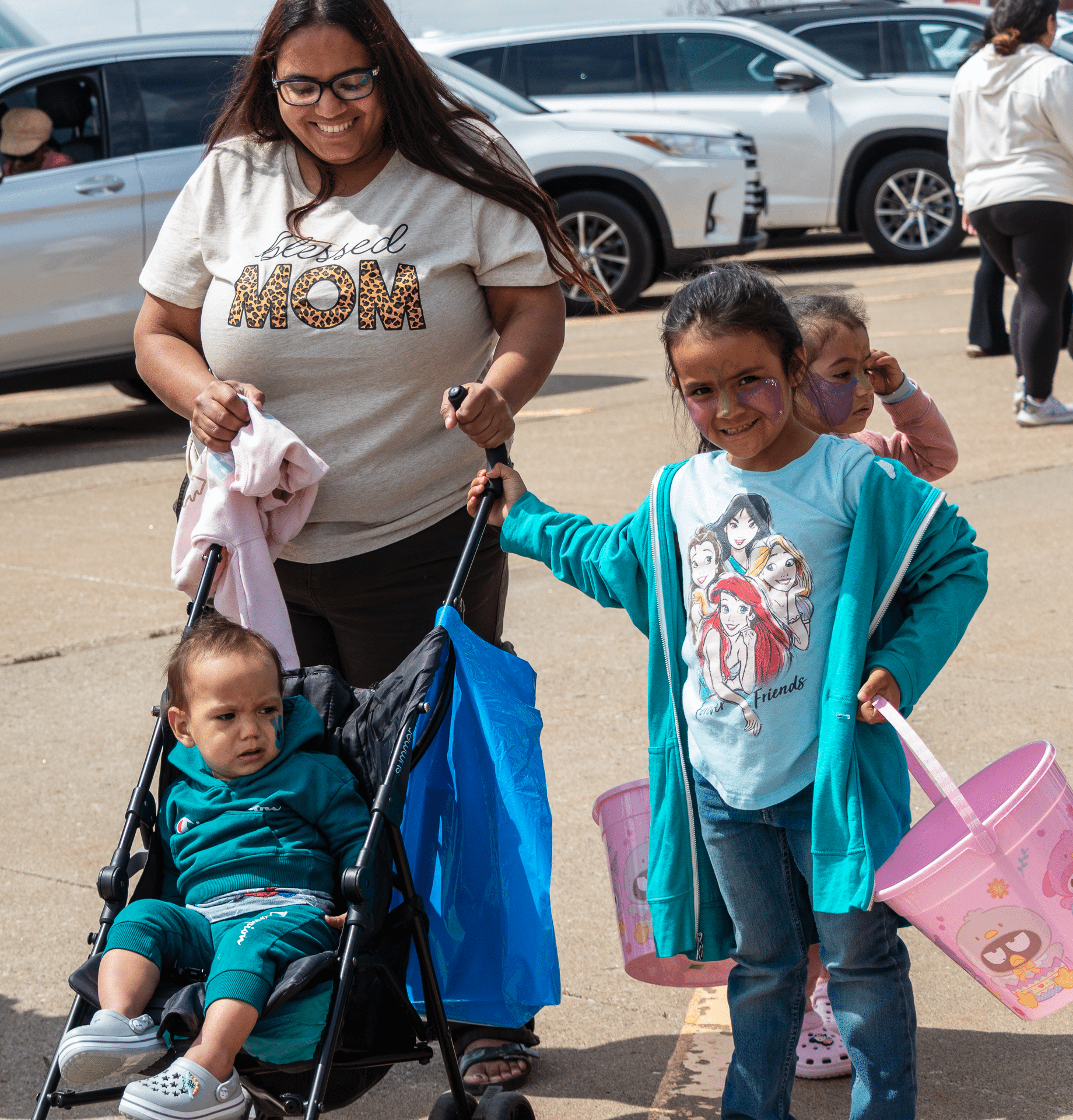 A woman and children, full of hope, walk together—reminding us all that everyone is welcome here. - Muscatine Church of Christ
