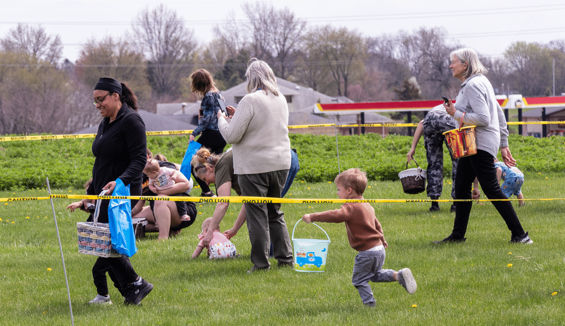 Adults and kids joyfully gather for an outdoor egg hunt—celebrating community, welcome, and hope together. - Muscatine Church of Christ