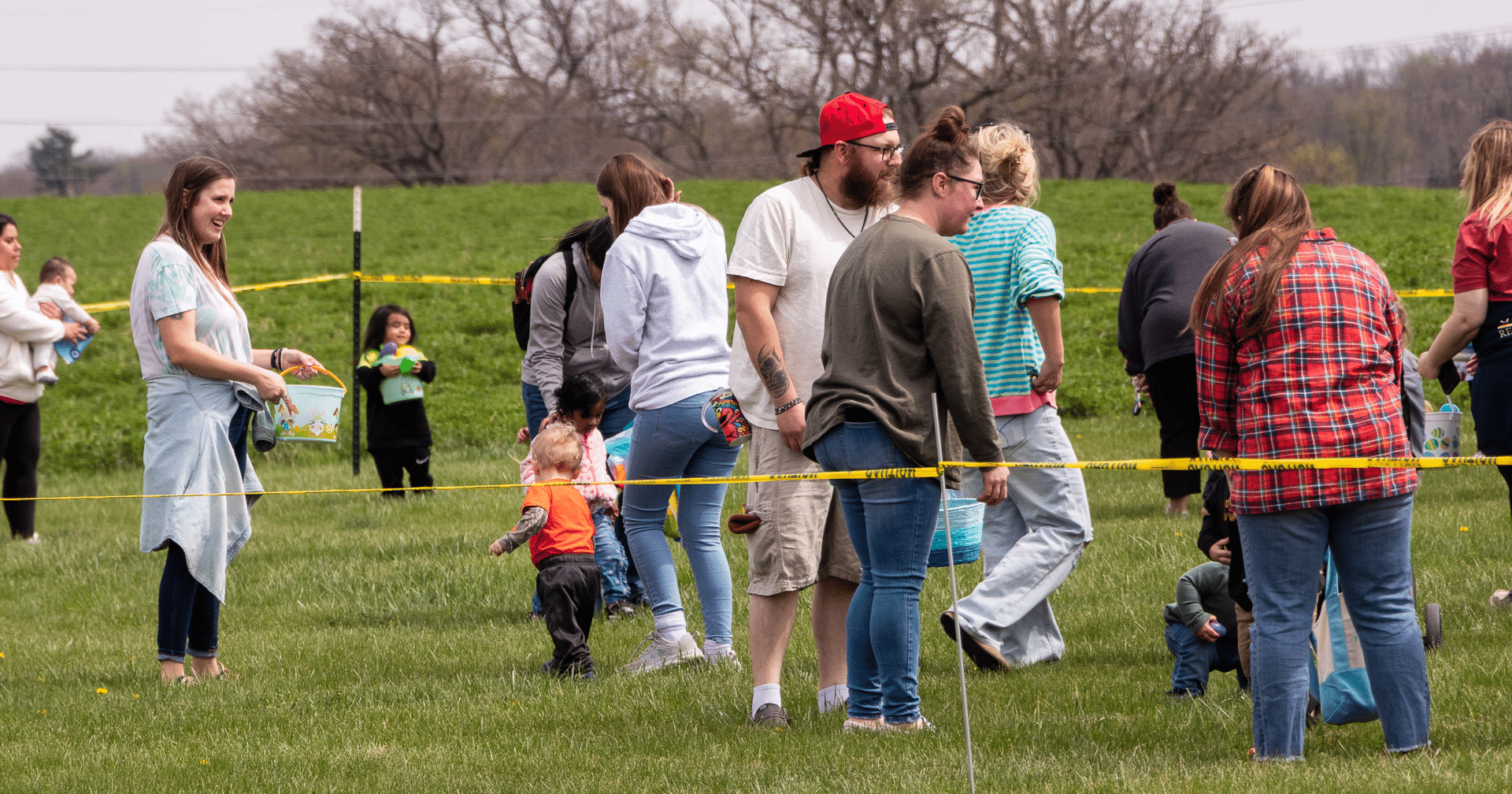 Families and children gather on the grass, sharing smiles and hope as a welcoming community celebrates together. - Muscatine Church of Christ
