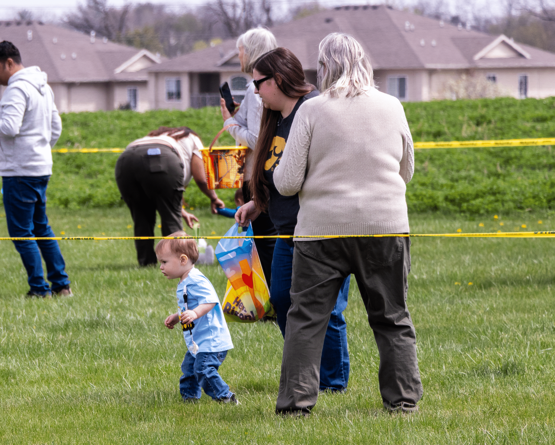 Welcoming families gather on the lawn, sharing smiles and hope as we seek joy together in our community. - Muscatine Church of Christ