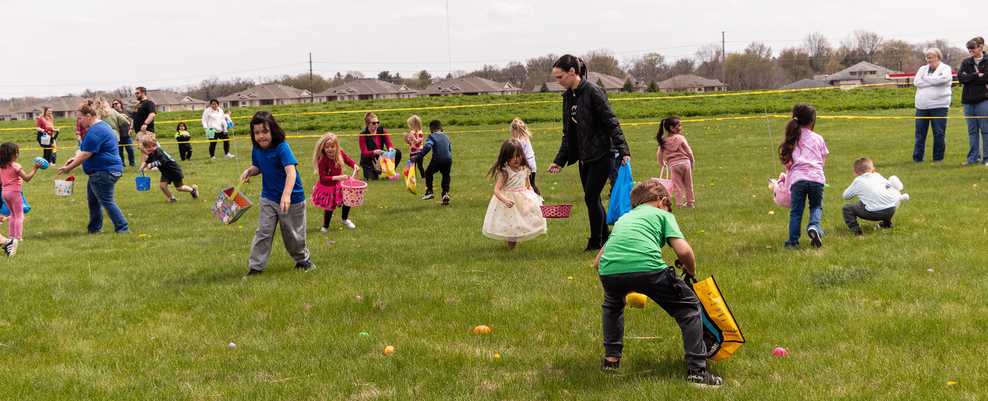 Families and friends joyfully hunt for colorful eggs together, sharing laughter, hope, and a warm welcome in our community. - Muscatine Church of Christ