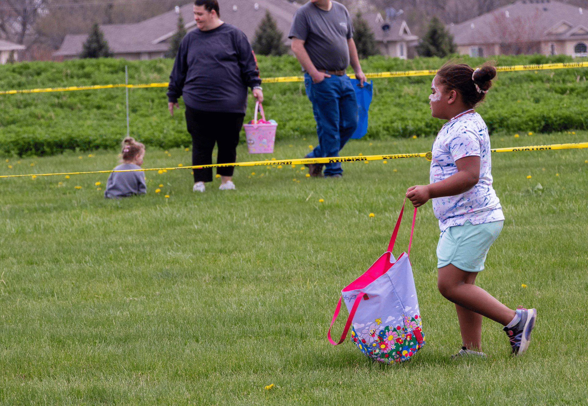 Children and adults joyfully hunt for eggs together on the church lawn, sharing smiles, laughter, and hope. - Muscatine Church of Christ