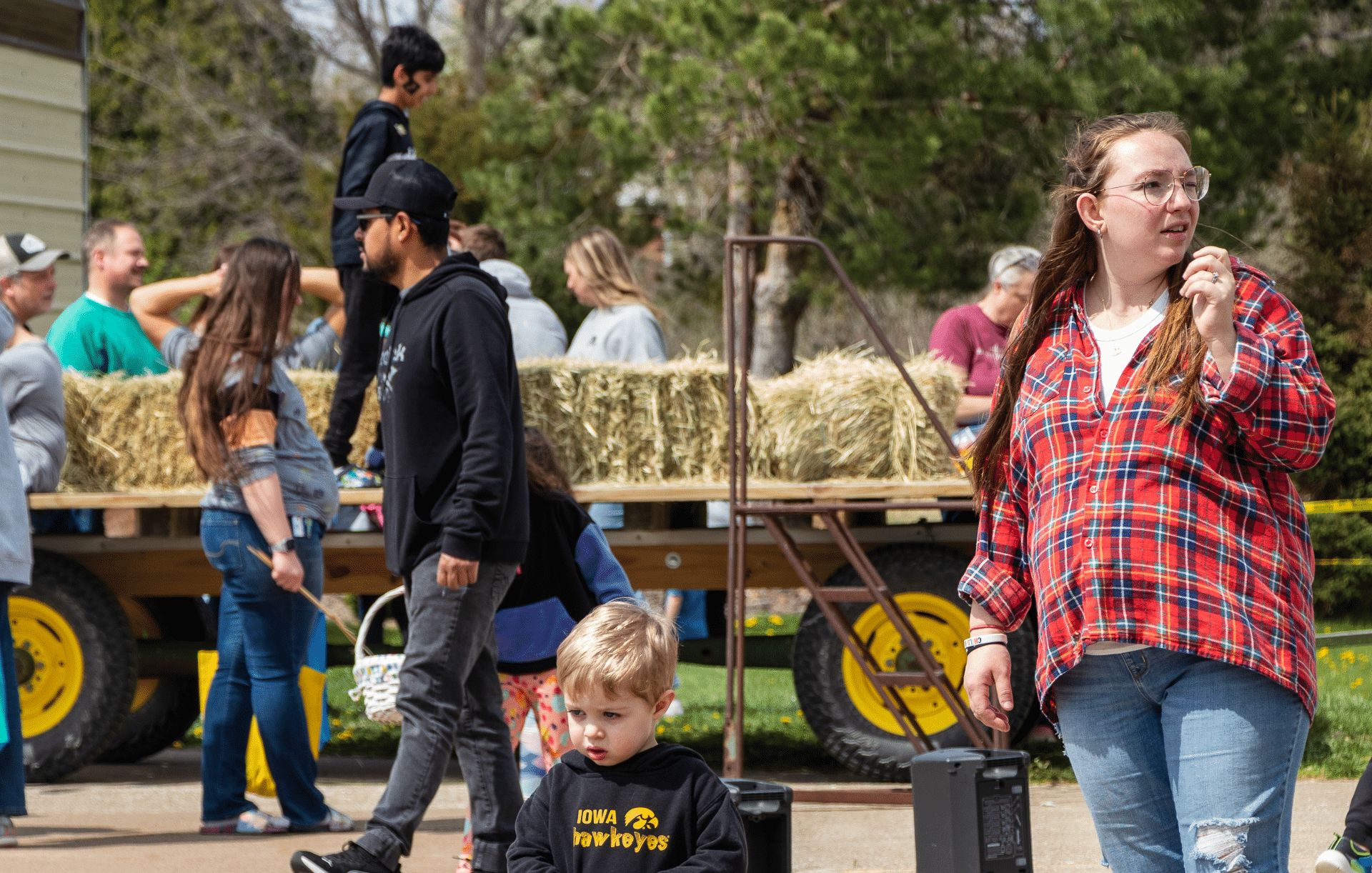 Families and friends gather outdoors, ready for a joyful hayride—everyone is welcome to share hope and community. - Muscatine Church of Christ