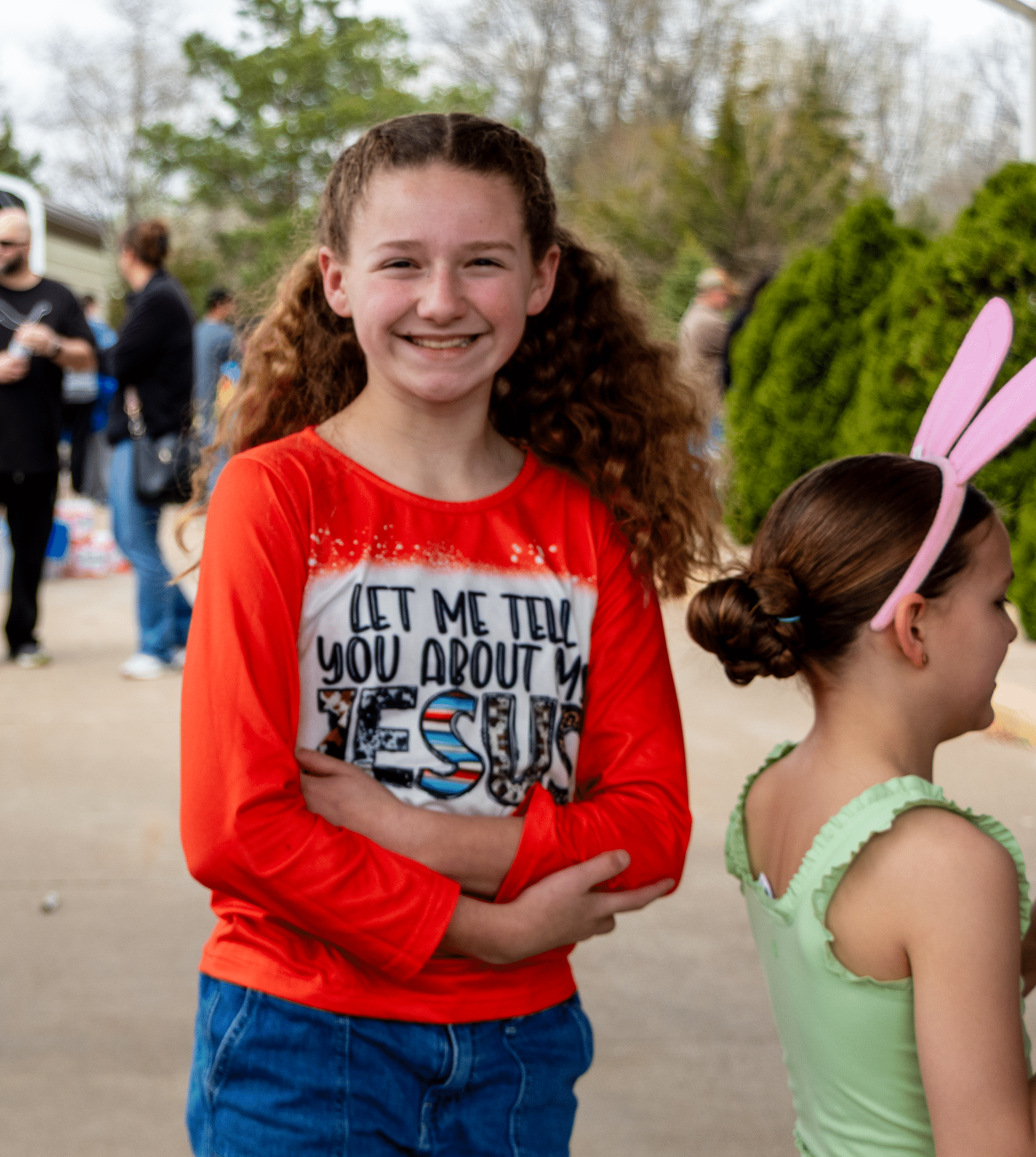 Two smiling children share a joyful moment outdoors, surrounded by friends and the warmth of our church family. - Muscatine Church of Christ