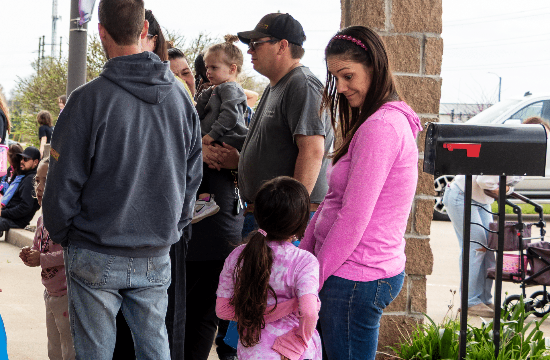 Adults and children gather outdoors, sharing smiles and conversation—a welcoming scene of community and hope. - Muscatine Church of Christ