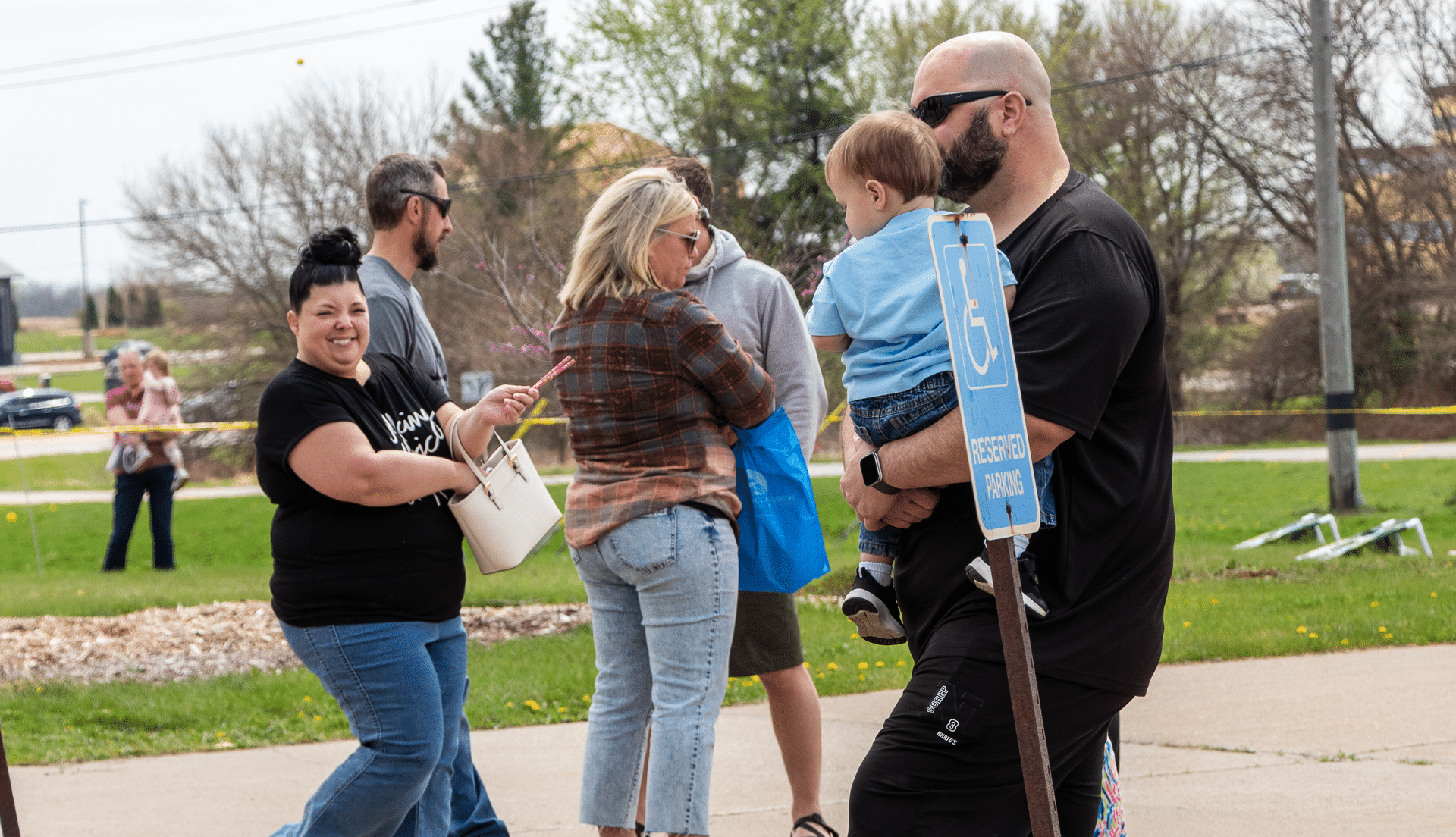 Welcoming friends of all ages walk together by our church, spreading hope and community on a cloudy day. - Muscatine Church of Christ