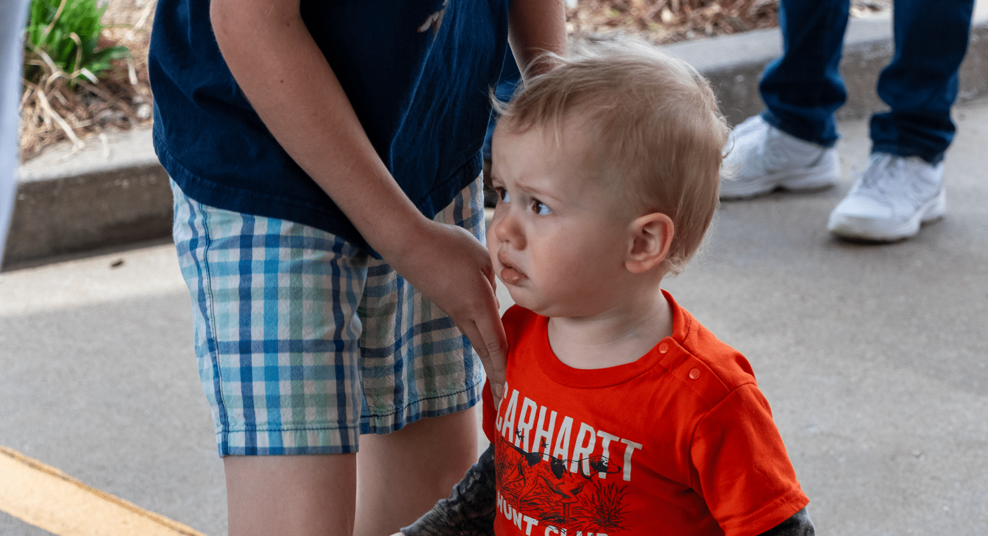 A young child holds an older child’s hand, finding comfort and hope together in our caring church family. - Muscatine Church of Christ