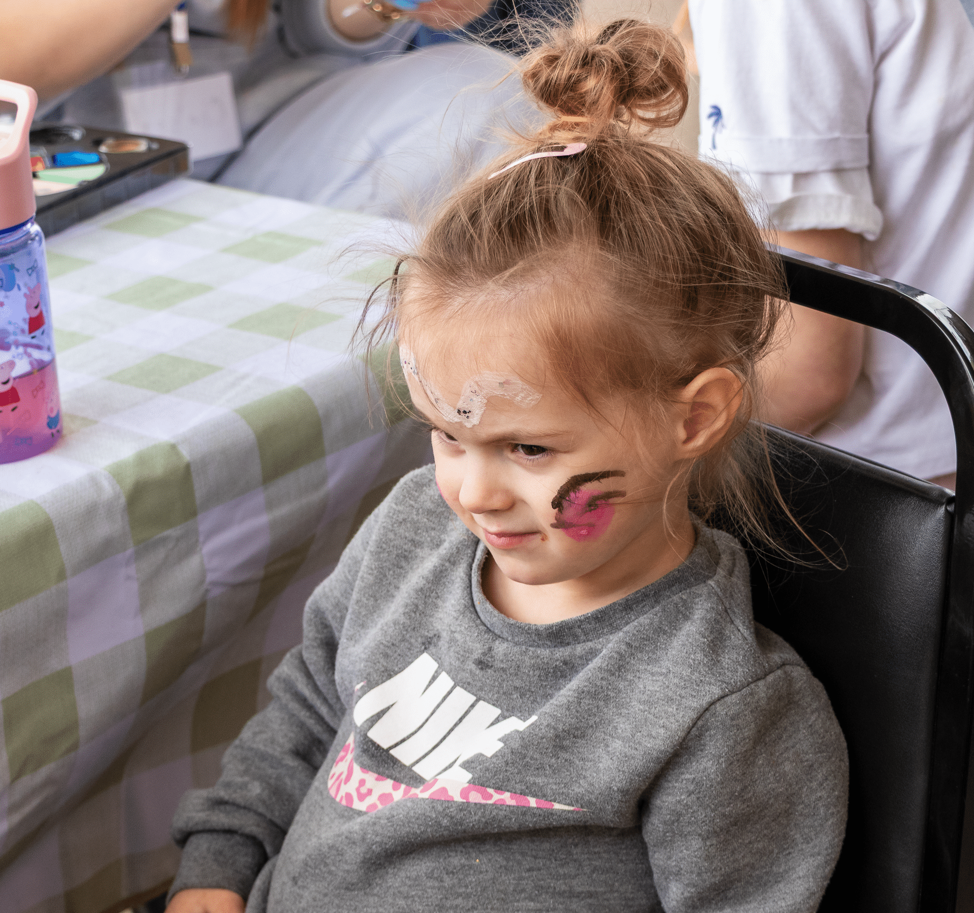 Smiling girl with face paint enjoys our gathering—everyone is welcome at Muscatine Church of Christ!. - Muscatine Church of Christ